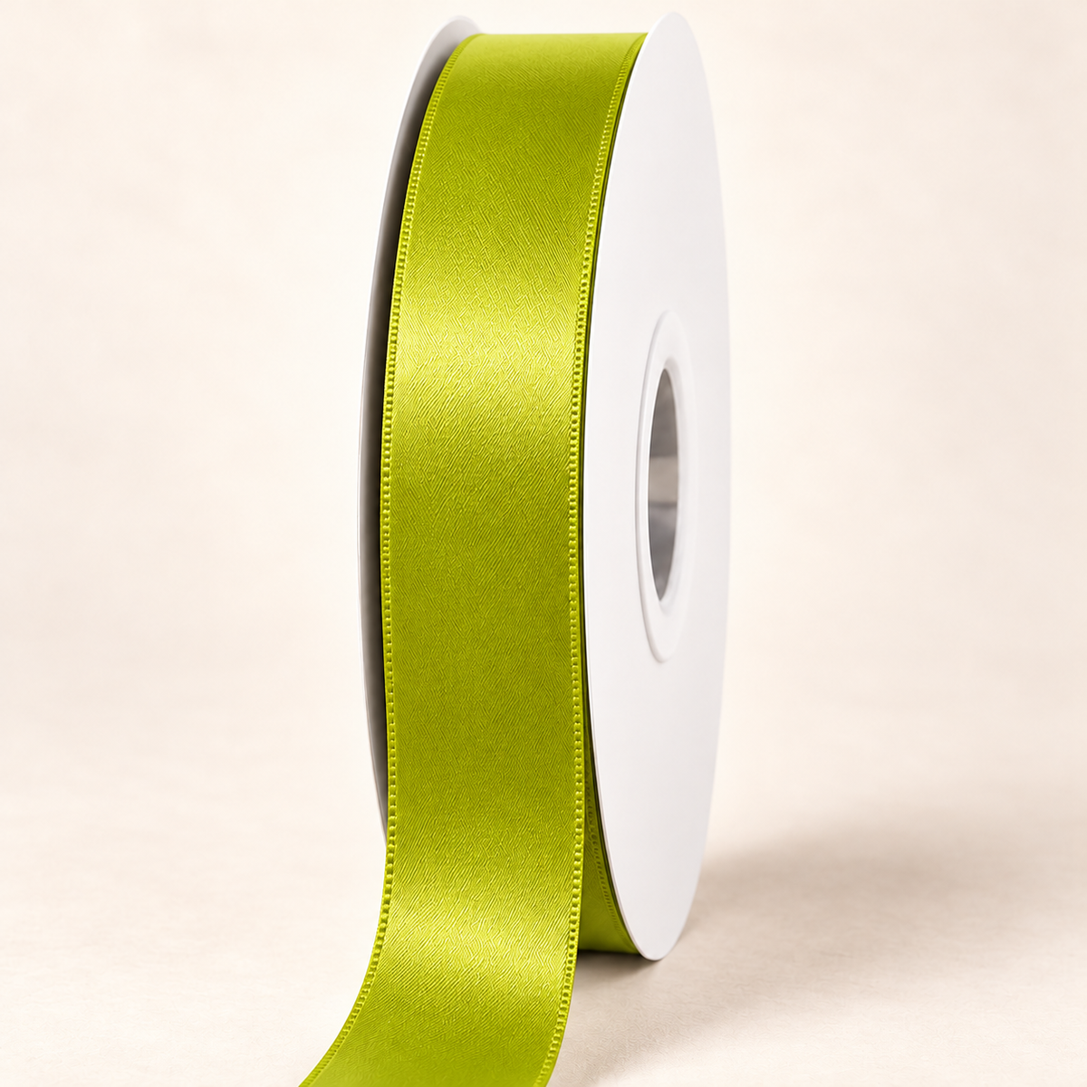 Acid Green — 22 mm satin ribbon on a white roll against an ivory background
