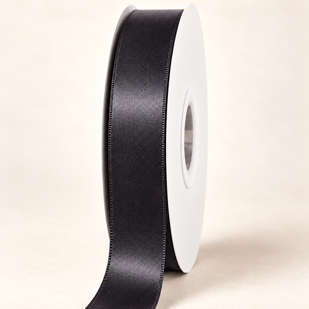 Black — 22 mm satin ribbon on a white roll against an ivory background