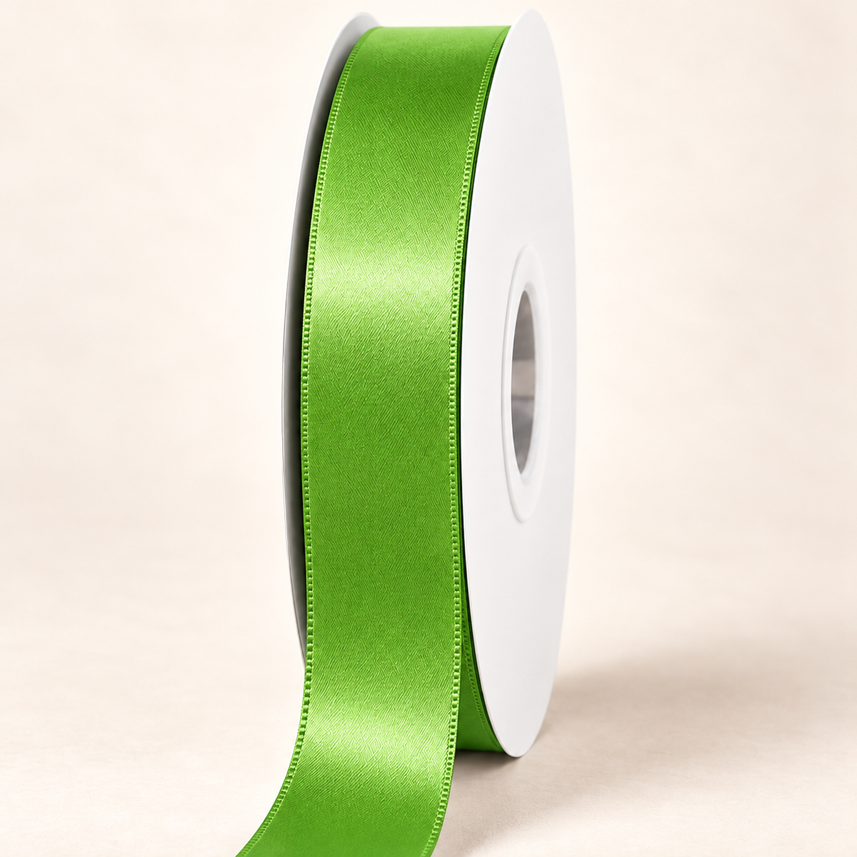 Bud Green — 22 mm satin ribbon on a white roll against an ivory background