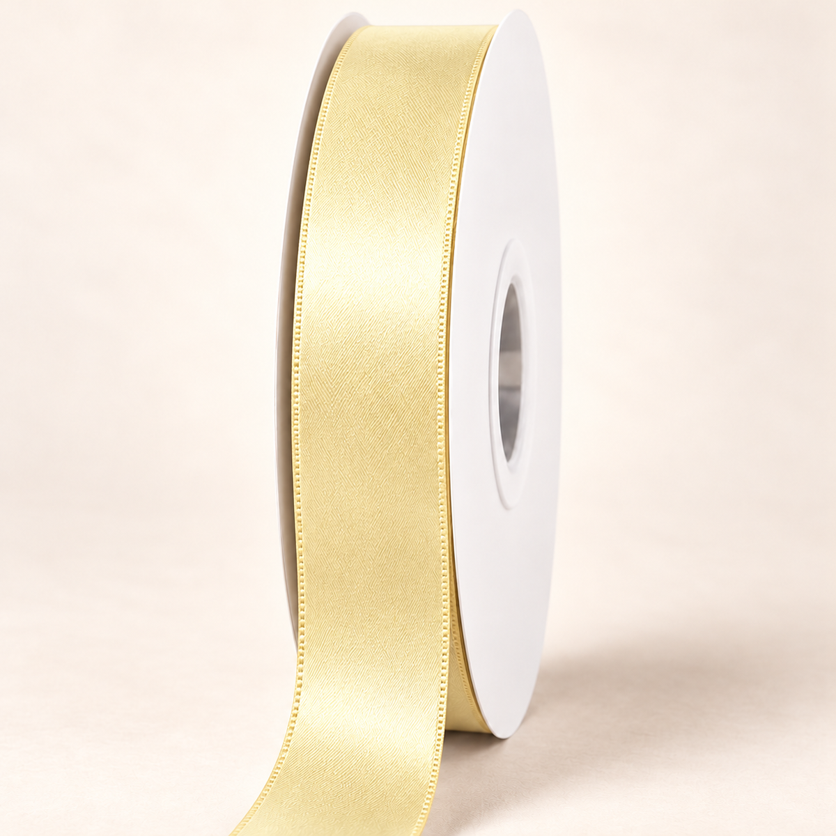 Buttercup — 22 mm satin ribbon on a white roll against an ivory background