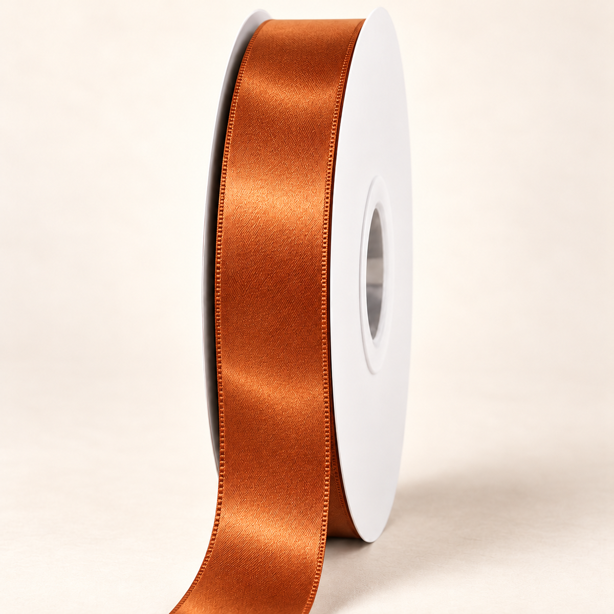 Copper — 22 mm satin ribbon on a white roll against an ivory background