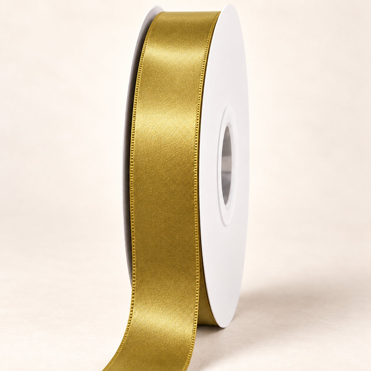 Golden Olive — 22 mm satin ribbon on a white roll against an ivory background