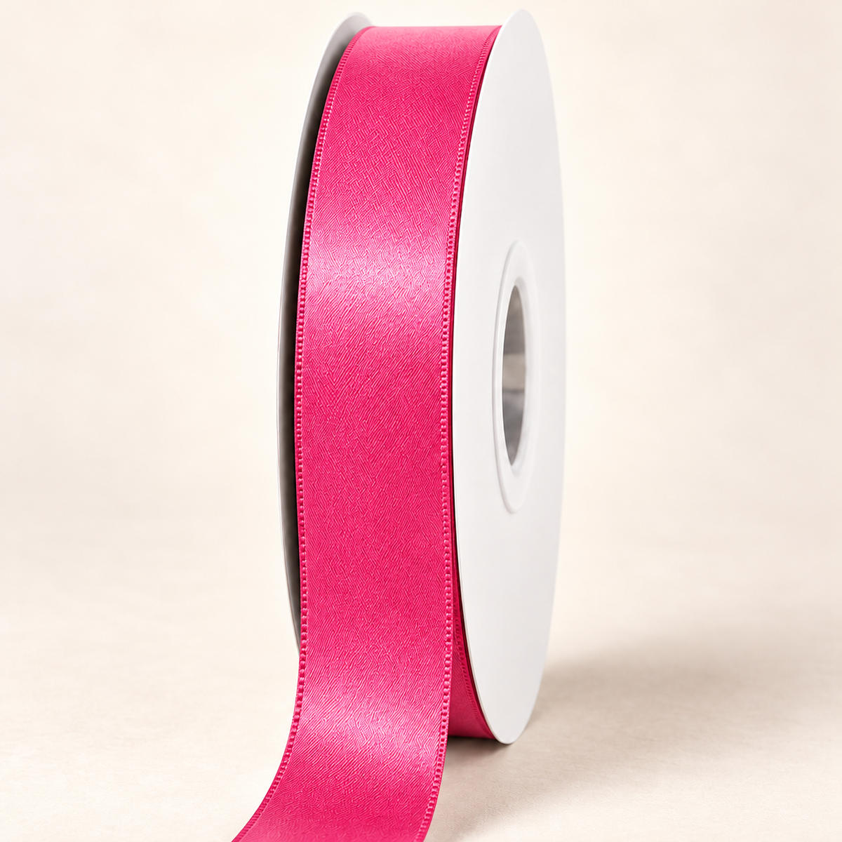 Hot Pink — 22 mm satin ribbon on a white roll against an ivory background