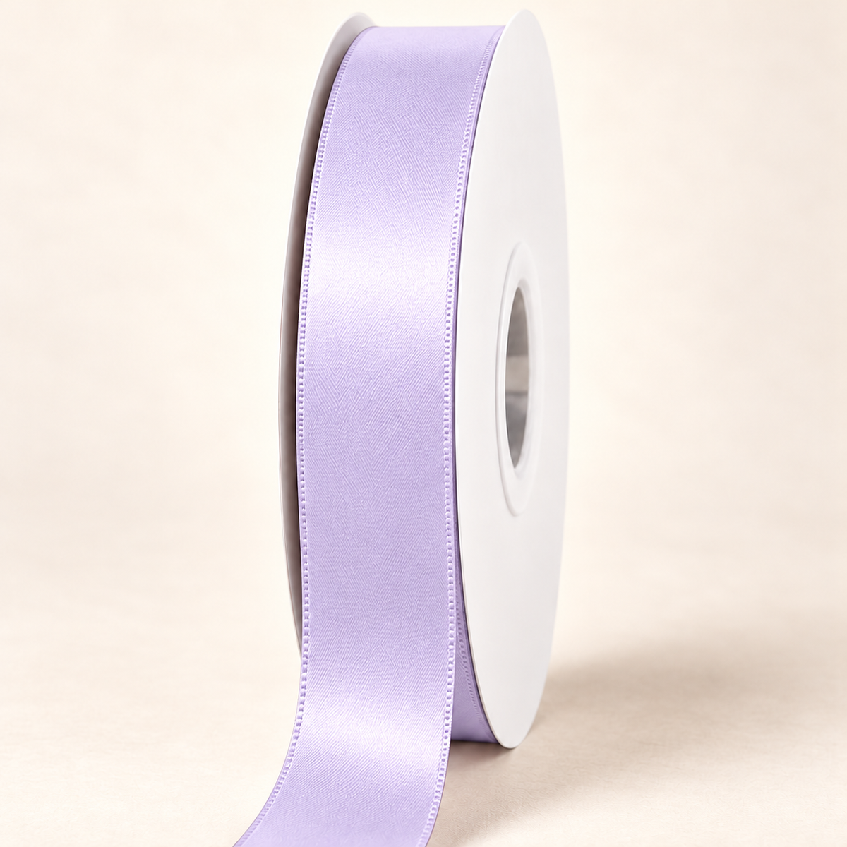 Lilac Mist — 22 mm satin ribbon on a white roll against an ivory background