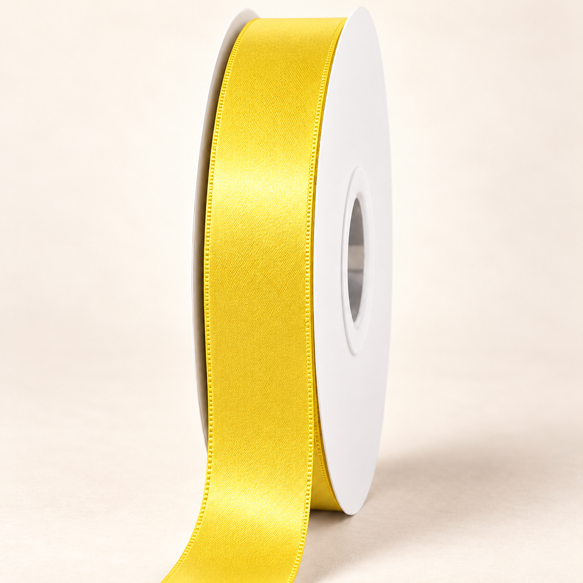 Yellow Gold — 22 mm satin ribbon on a white roll against an ivory background