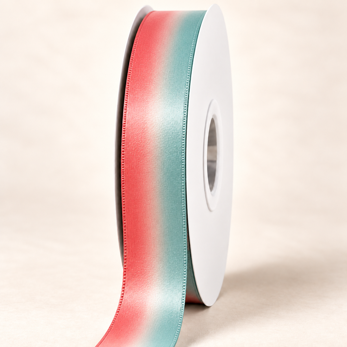 Flamingo Bay satin ribbon on a white spool with coral pink and pale aqua