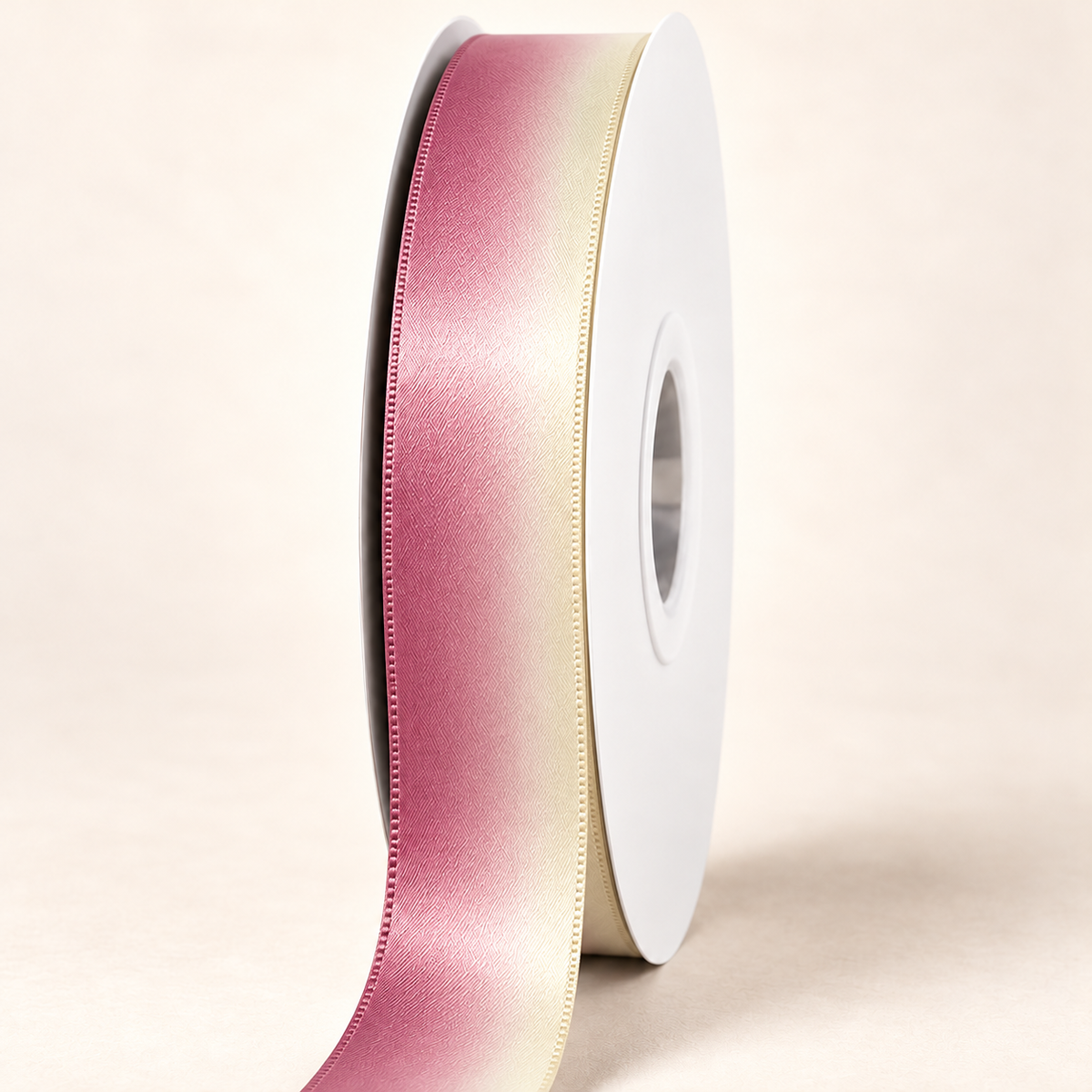 Guava Creme Satin Ribbon — 22 mm satin ribbon on a white roll against an ivory background