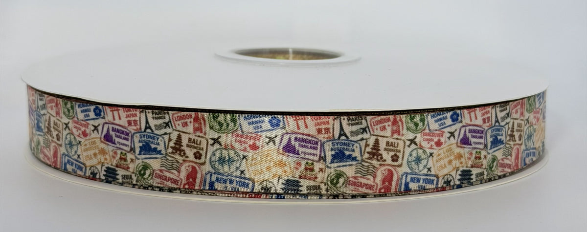 Actual Jetsetter ribbon roll showing cream with multicolored travel stamps