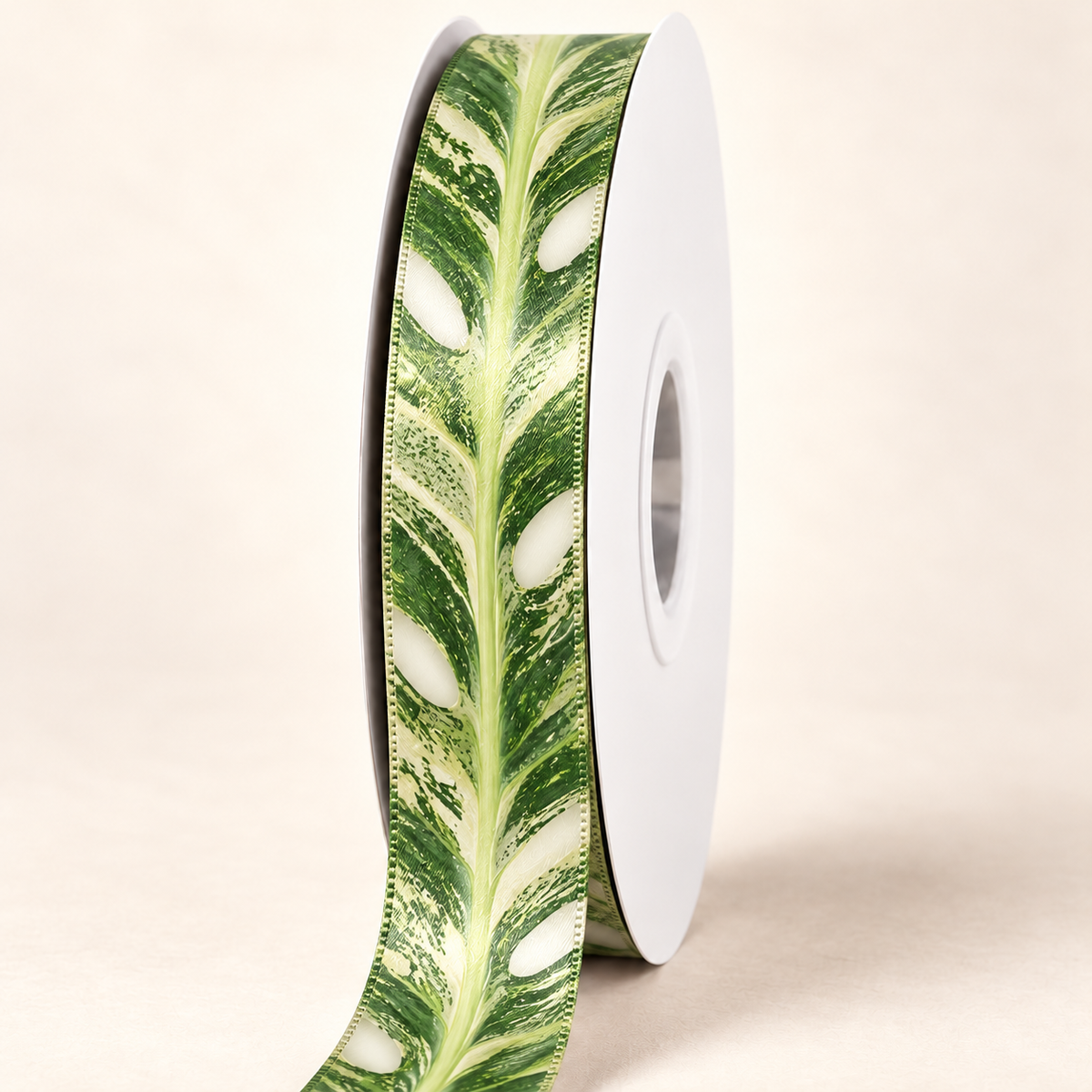Monstera Thai Constellation Double-faced Satin Ribbon — 22 mm satin ribbon on a white roll against an ivory background