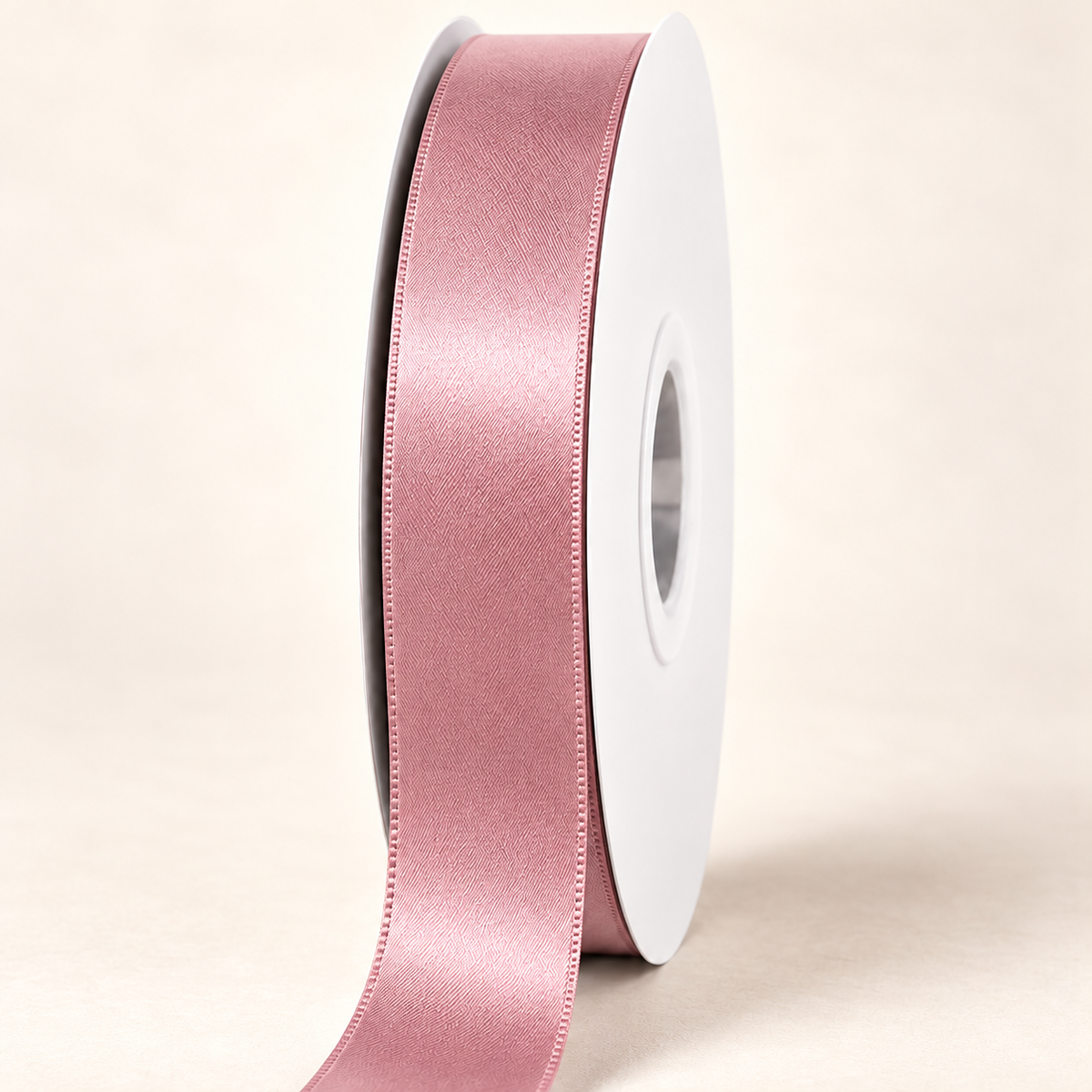 Antique Mauve — 22 mm satin ribbon on a white roll against an ivory background