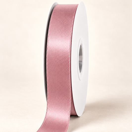 Antique Mauve — 22 mm satin ribbon on a white roll against an ivory background