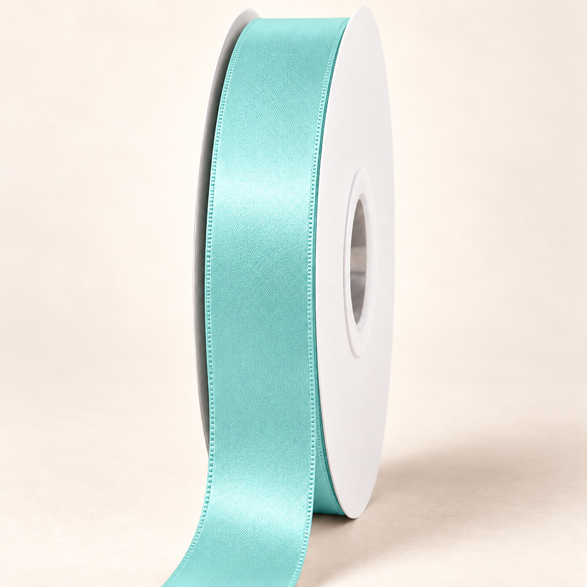 Aqua — 22 mm satin ribbon on a white roll against an ivory background