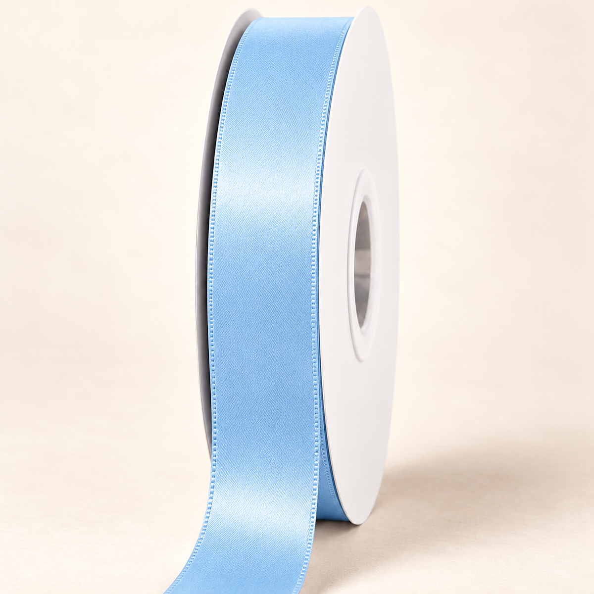 Blue Mist — 22 mm satin ribbon on a white roll against an ivory background