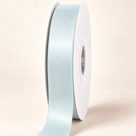 Blue Vapor — 22 mm satin ribbon on a white roll against an ivory background