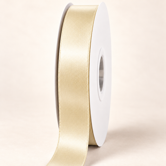 Buttermilk — 22 mm satin ribbon on a white roll against an ivory background