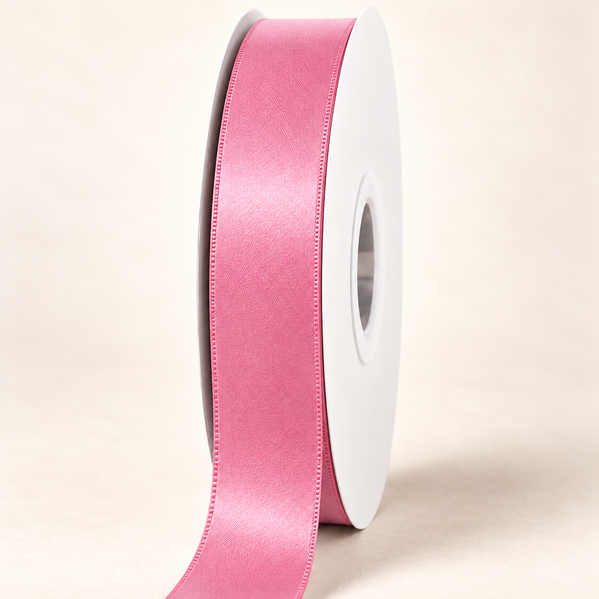 Camilia Rose — 22 mm satin ribbon on a white roll against an ivory background