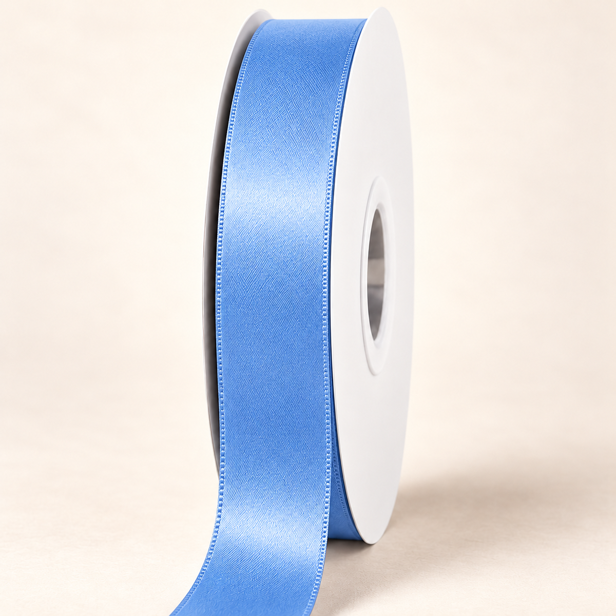 Capri Blue — 22 mm satin ribbon on a white roll against an ivory background