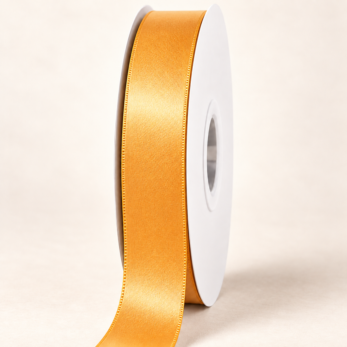Chamois — 22 mm satin ribbon on a white roll against an ivory background