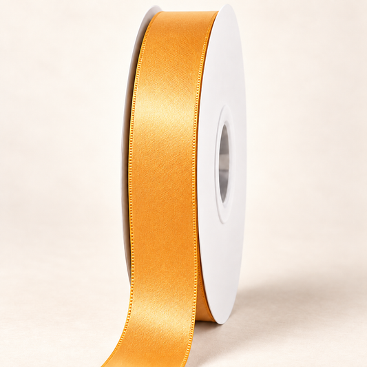 Chamois — 22 mm satin ribbon on a white roll against an ivory background
