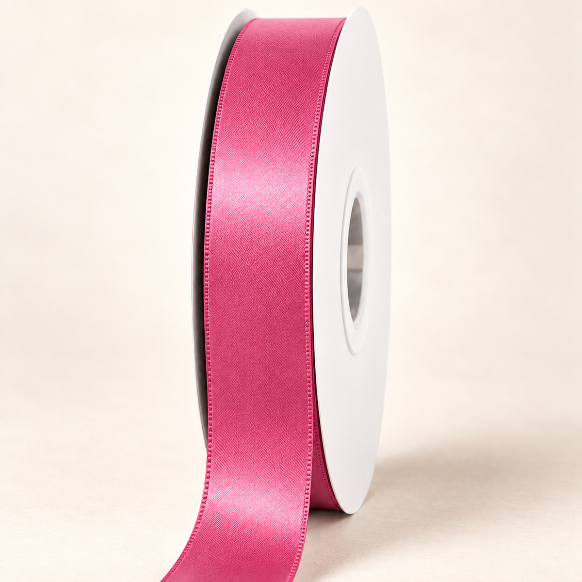 Colonial Rose — 22 mm satin ribbon on a white roll against an ivory background