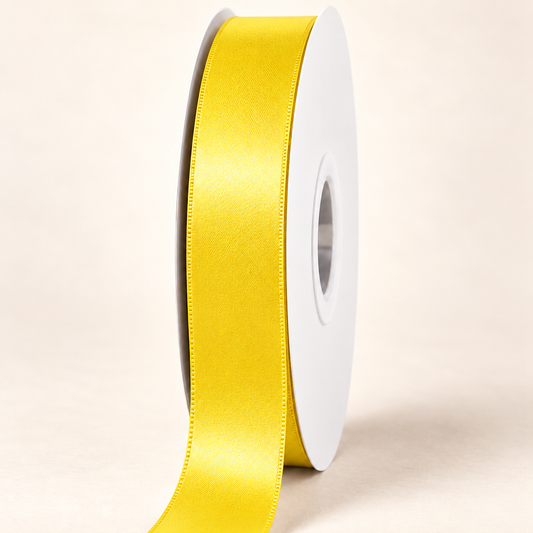 Daffodil — 22 mm satin ribbon on a white roll against an ivory background