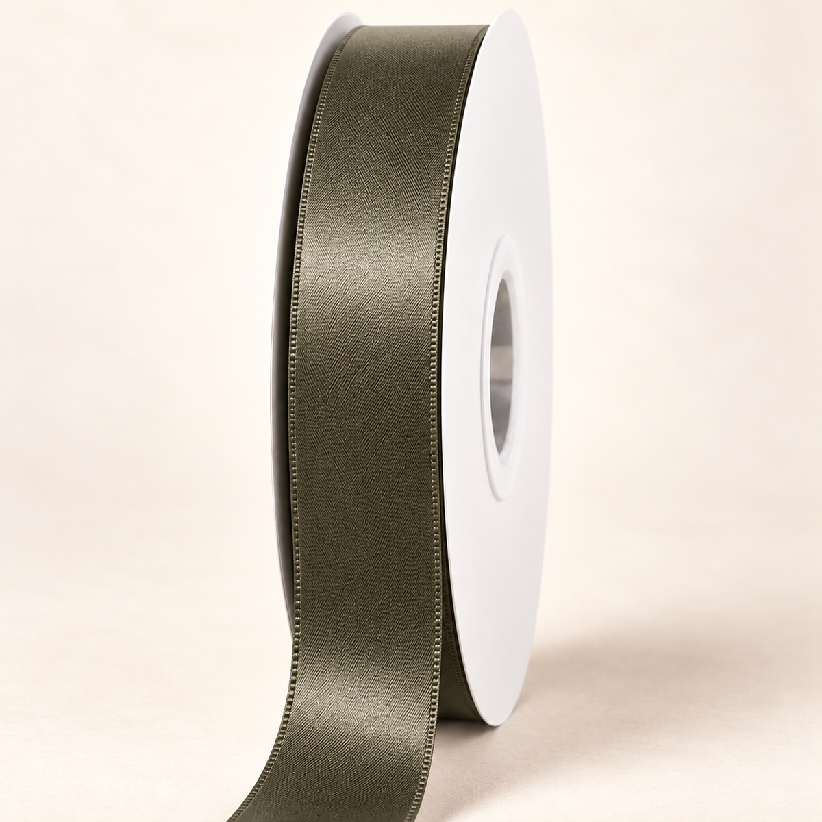 Deep Sage — 22 mm satin ribbon on a white roll against an ivory background