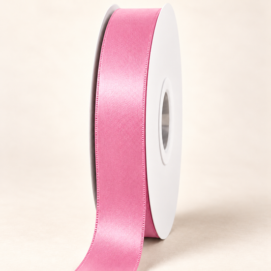 Dusty Rose — 22 mm satin ribbon on a white roll against an ivory background