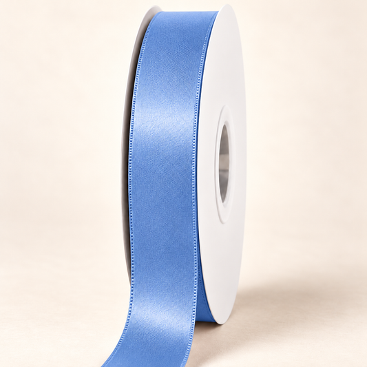 French Blue — 22 mm satin ribbon on a white roll against an ivory background