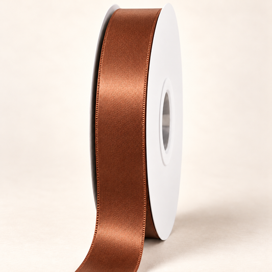 Golden Brown — 22 mm satin ribbon on a white roll against an ivory background