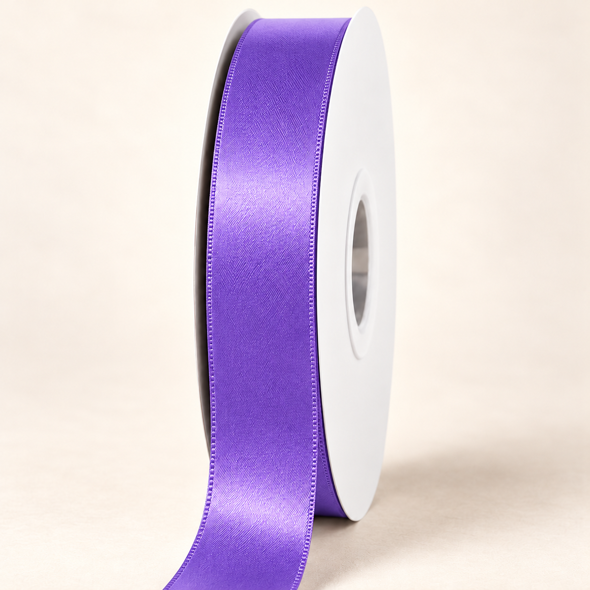 Grape — 22 mm satin ribbon on a white roll against an ivory background