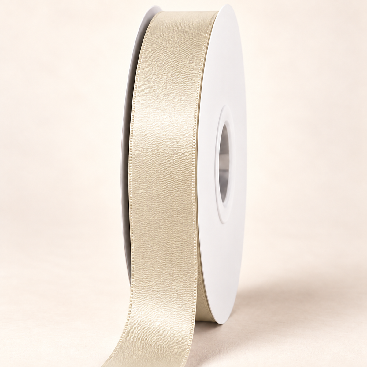 Ivory — 22 mm satin ribbon on a white roll against an ivory background