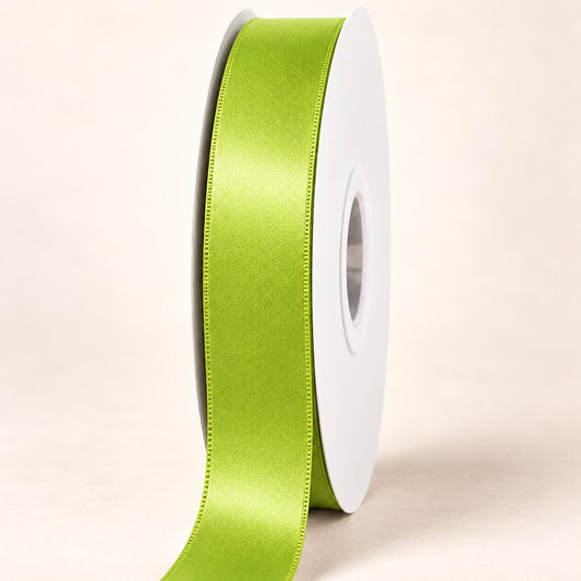 Jasmine Green — 22 mm satin ribbon on a white roll against an ivory background