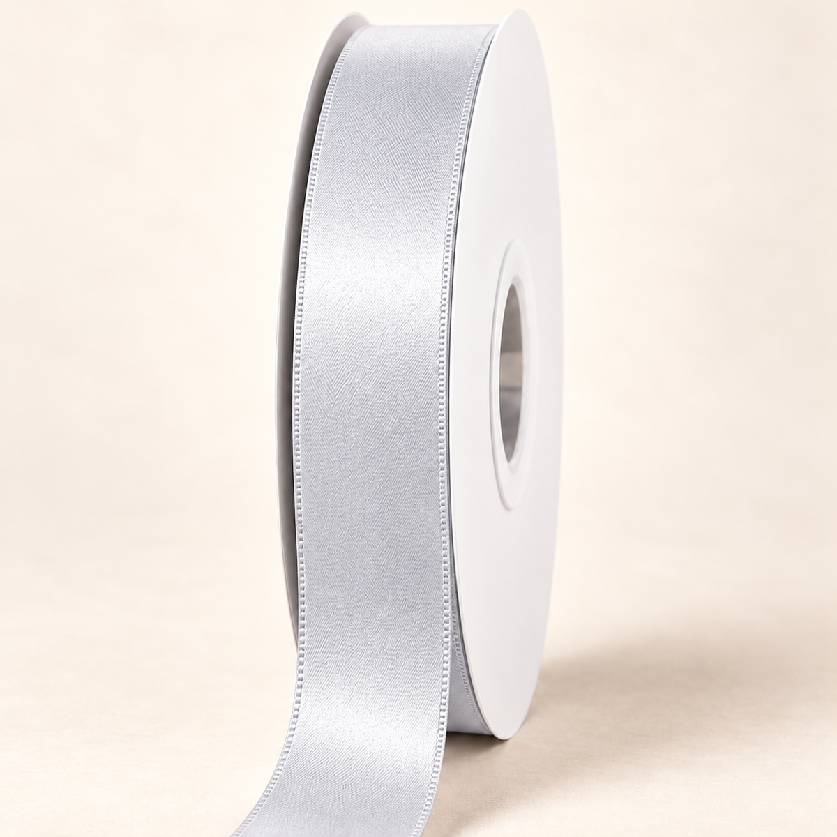 Light Silver — 22 mm satin ribbon on a white roll against an ivory background