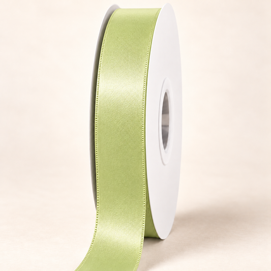 Lime Juice — 22 mm satin ribbon on a white roll against an ivory background
