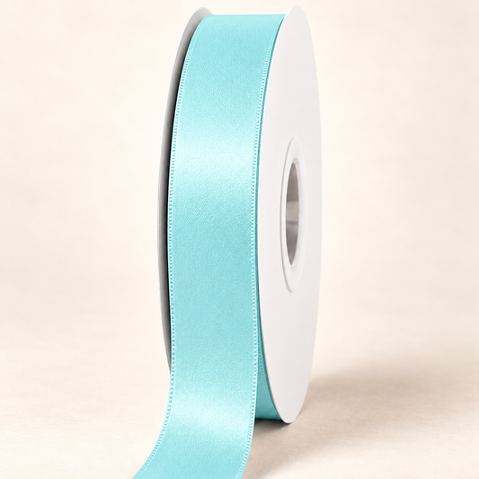 Mineral Ice — 22 mm satin ribbon on a white roll against an ivory background