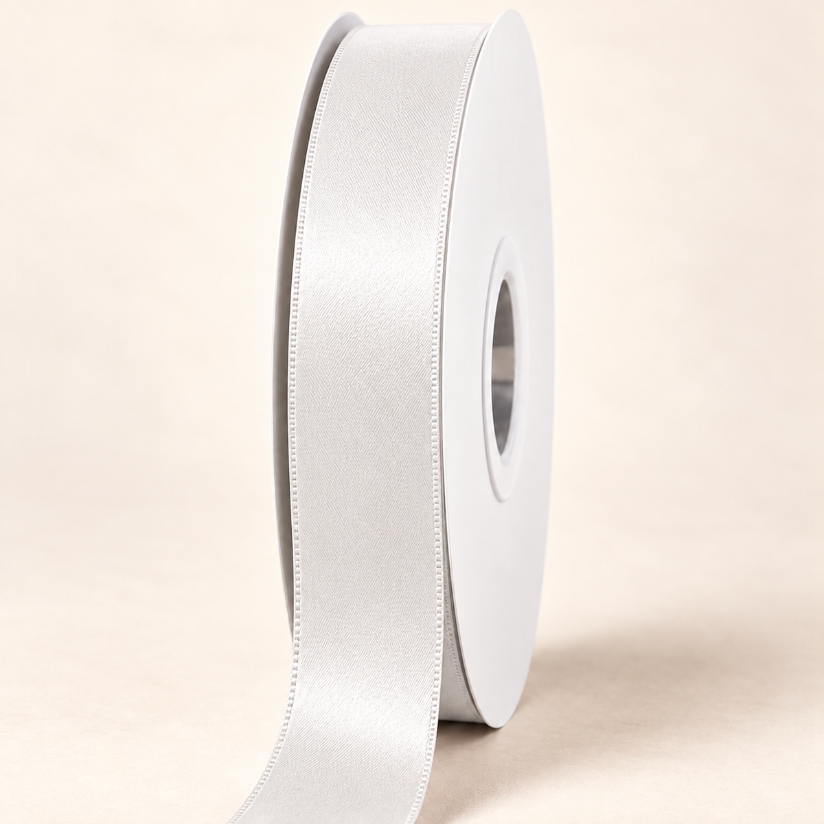 Off White — 22 mm satin ribbon on a white roll against an ivory background