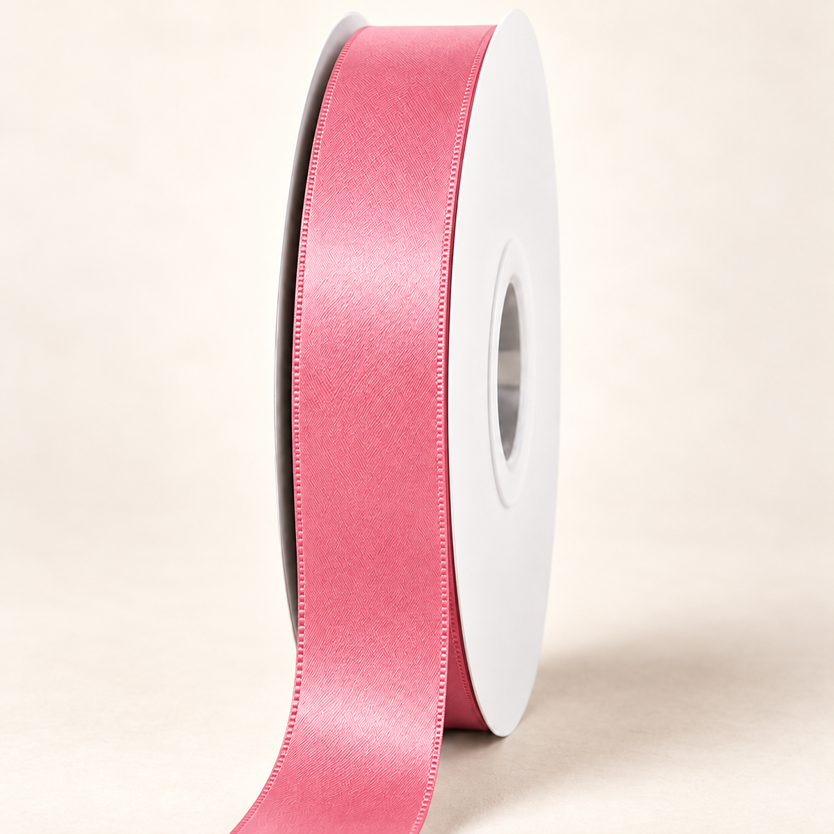 Passion Fruit — 22 mm satin ribbon on a white roll against an ivory background