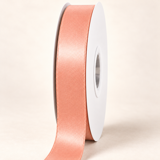 Peach — 22 mm satin ribbon on a white roll against an ivory background