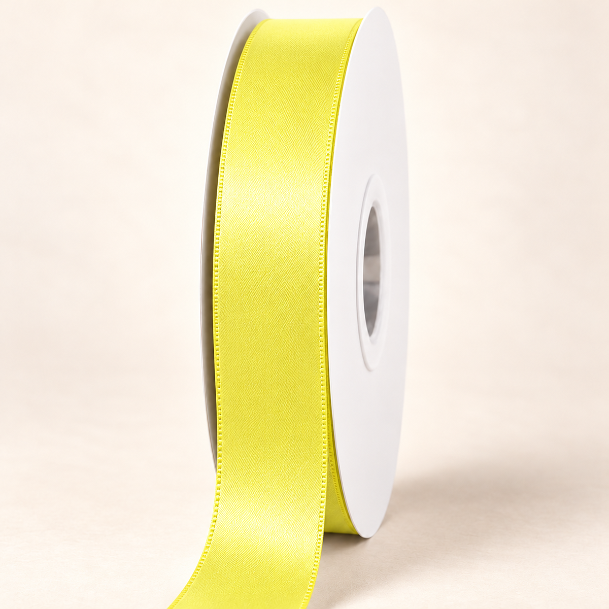 Pistachio — 22 mm satin ribbon on a white roll against an ivory background