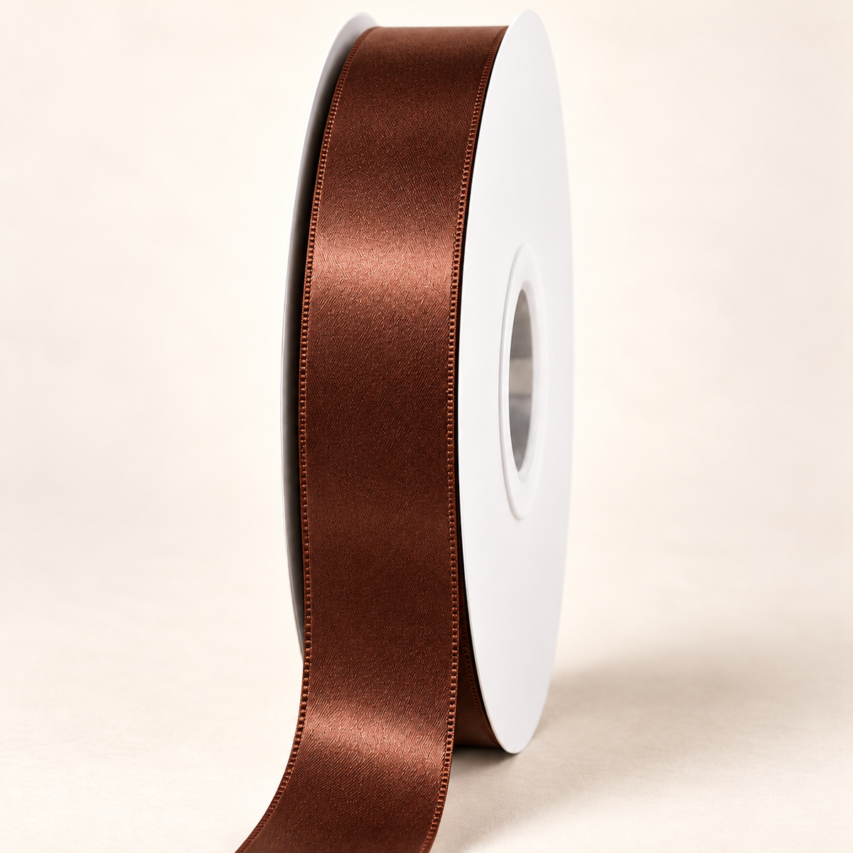 Root Beer — 22 mm satin ribbon on a white roll against an ivory background