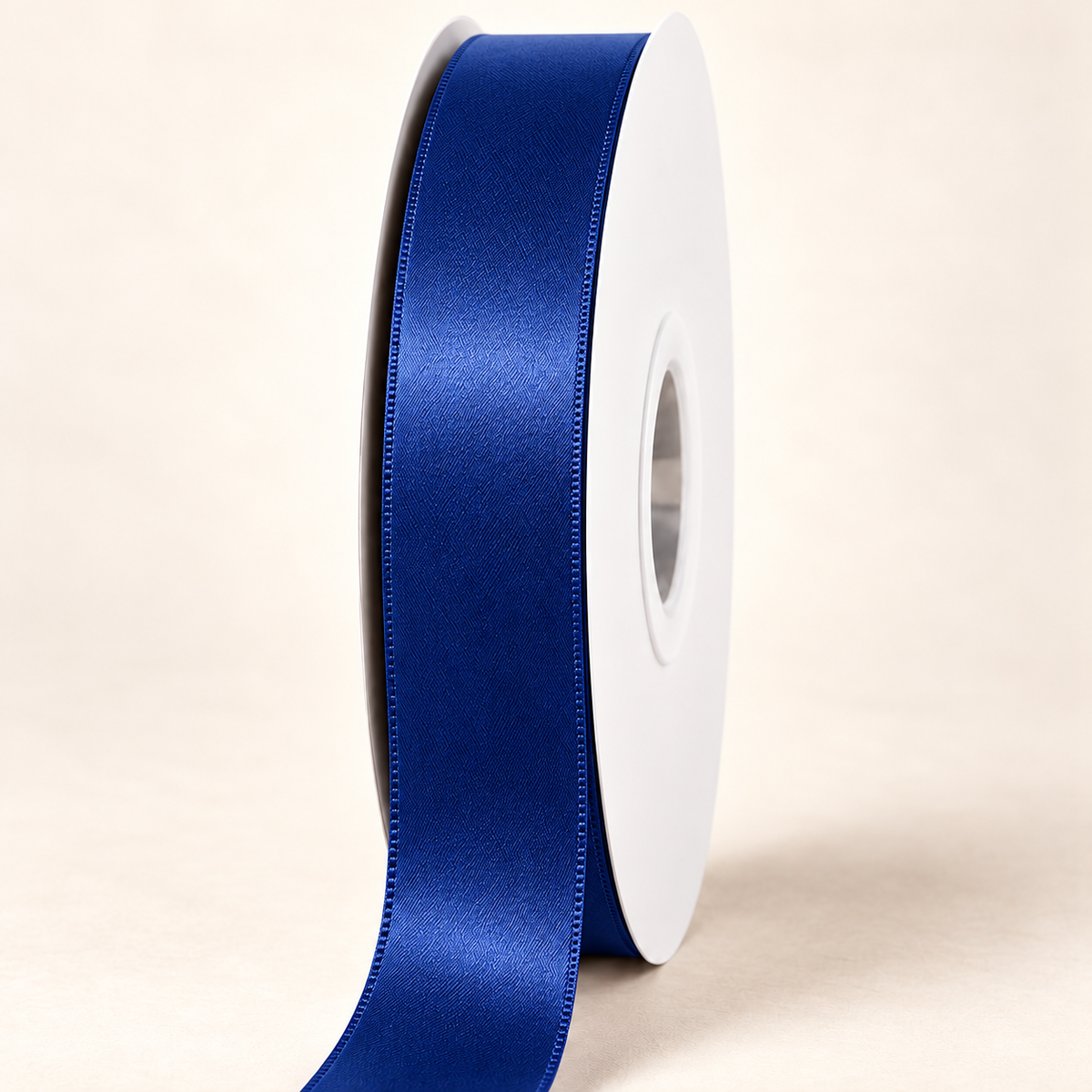 Royal — 22 mm satin ribbon on a white roll against an ivory background