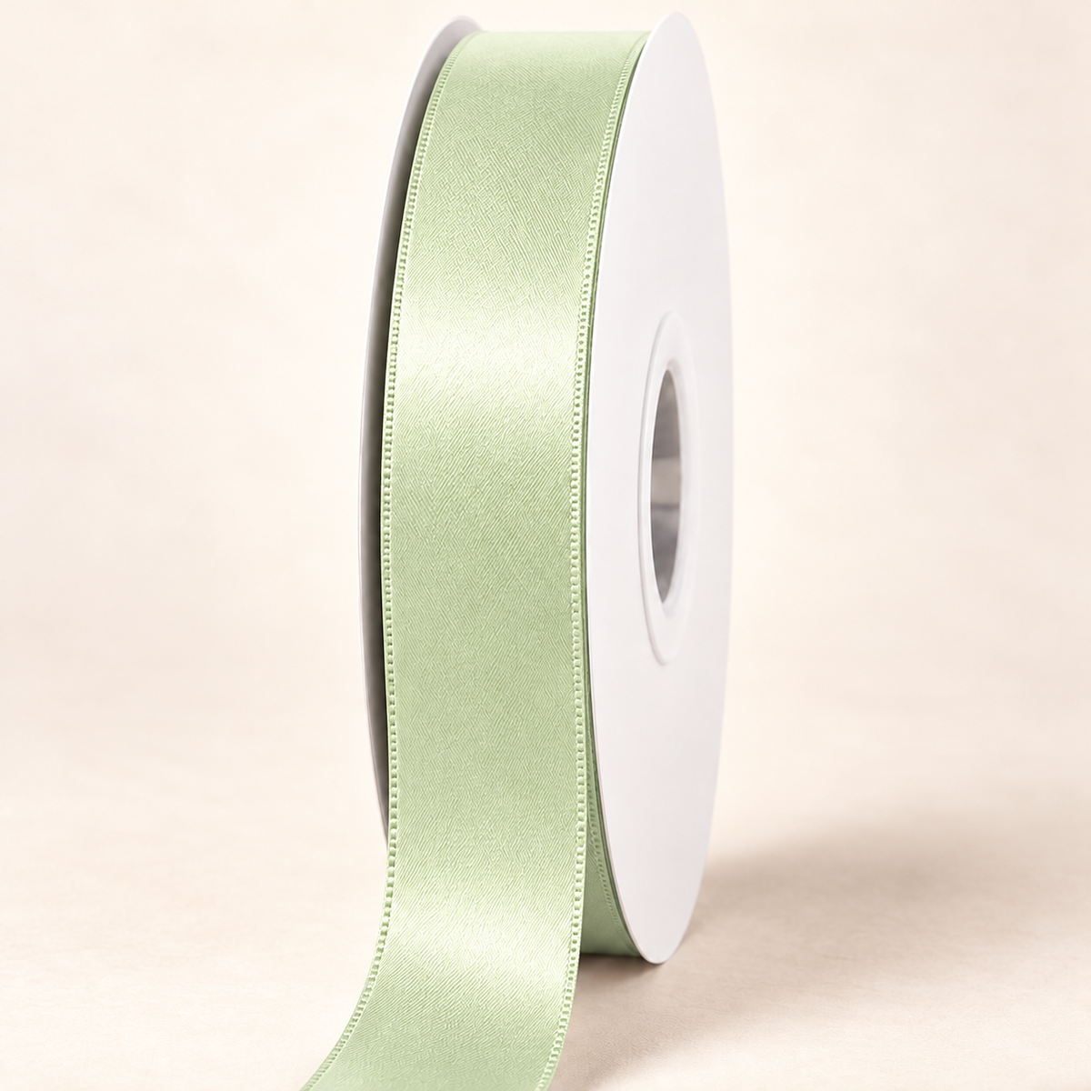 Seafoam Green — 22 mm satin ribbon on a white roll against an ivory background