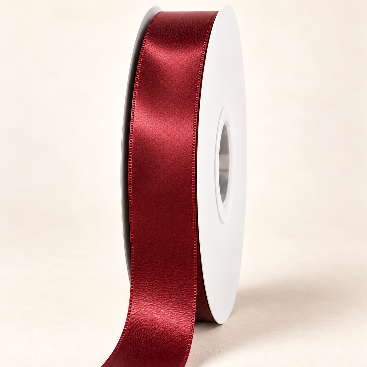 Sherry — 22 mm satin ribbon on a white roll against an ivory background