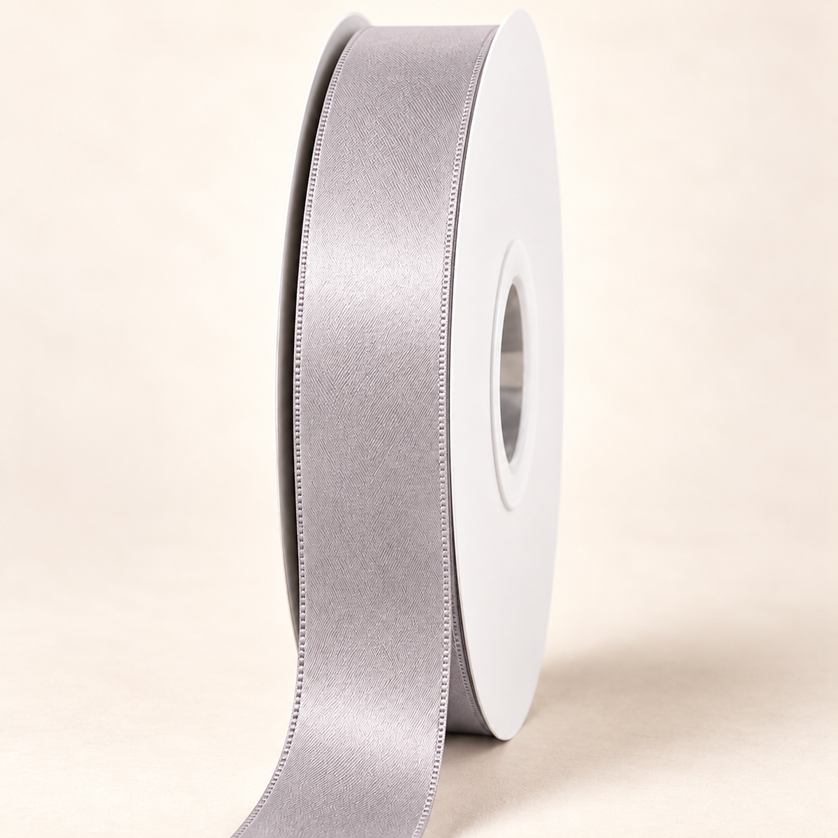 Silver — 22 mm satin ribbon on a white roll against an ivory background