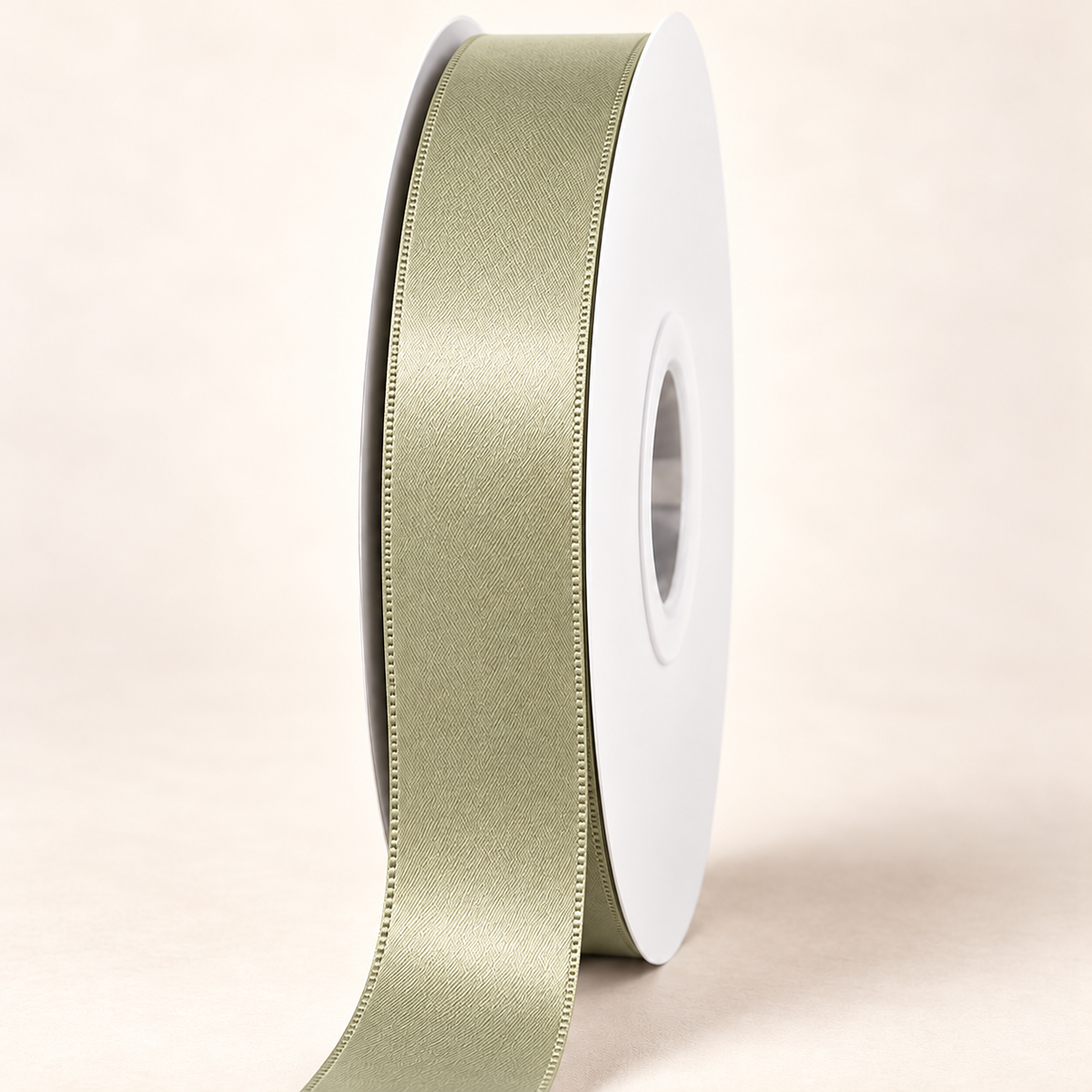 Soft Pine — 22 mm satin ribbon on a white roll against an ivory background