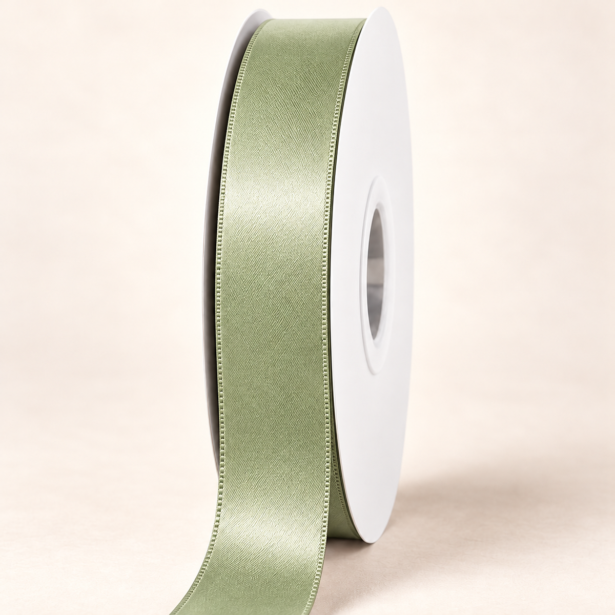 Spring Moss — 22 mm satin ribbon on a white roll against an ivory background
