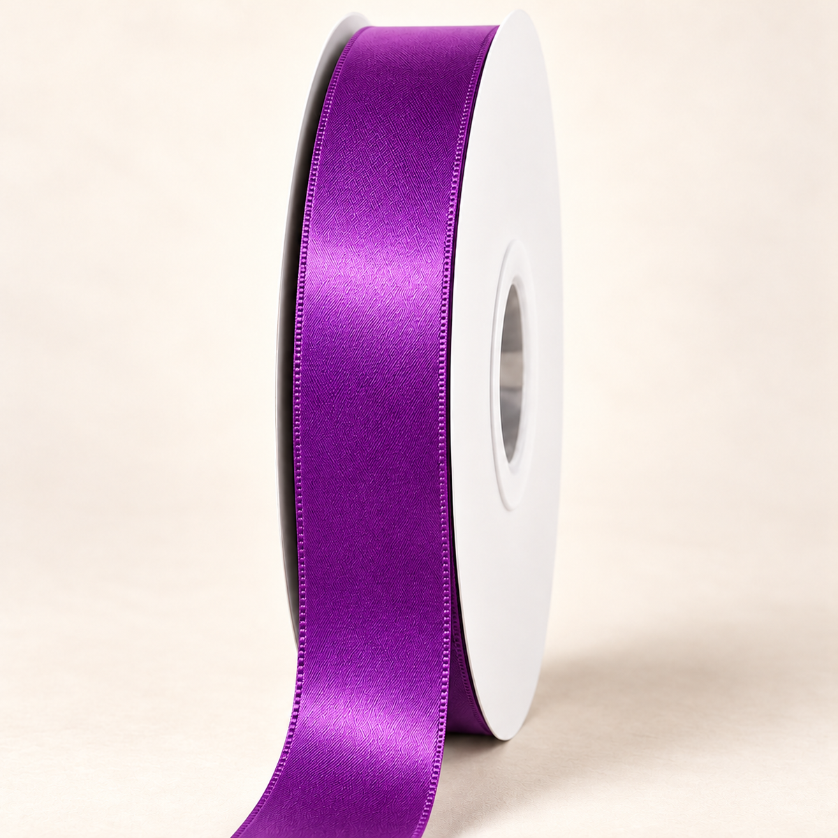 Ultra Violet — 22 mm satin ribbon on a white roll against an ivory background