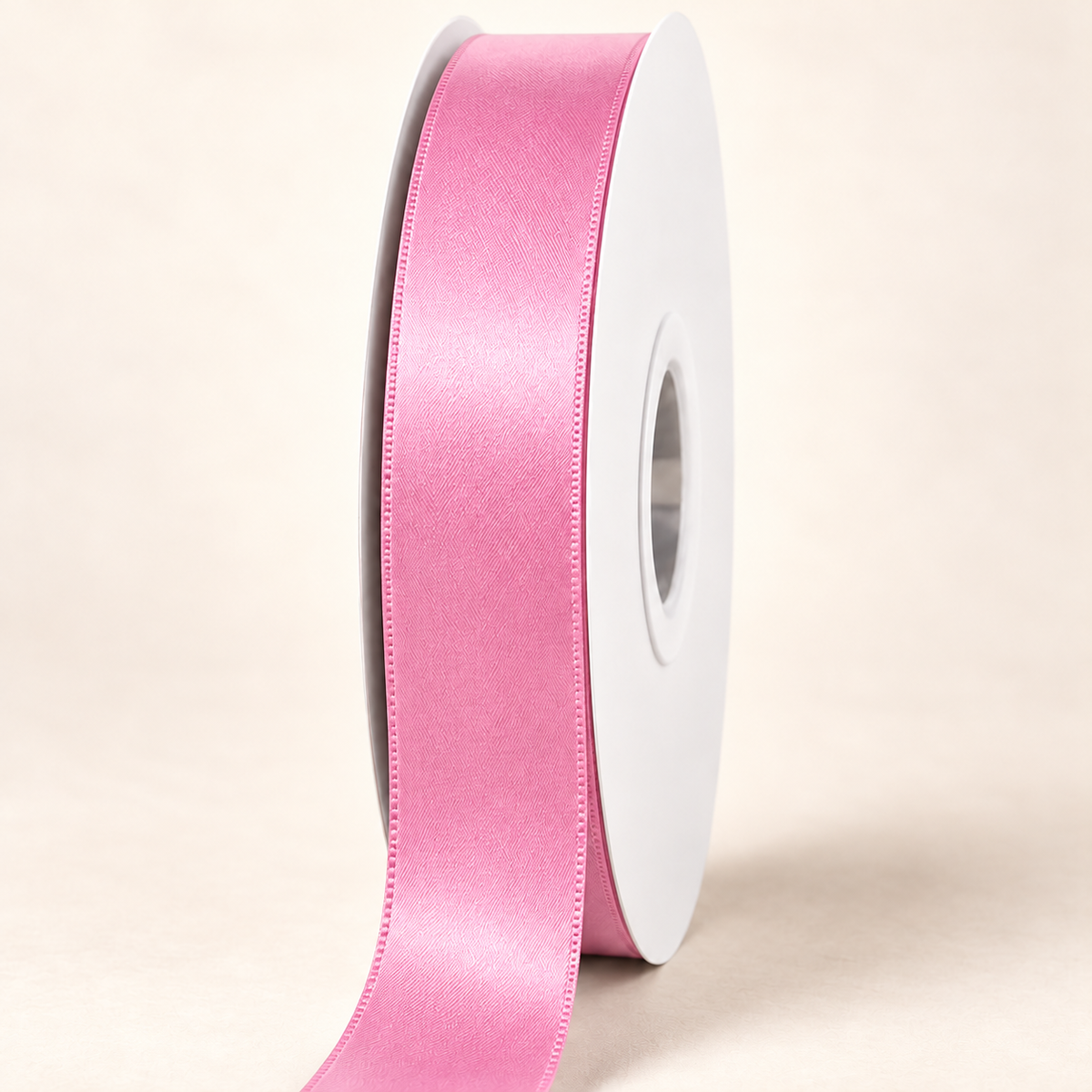 Wild Rose — 22 mm satin ribbon on a white roll against an ivory background