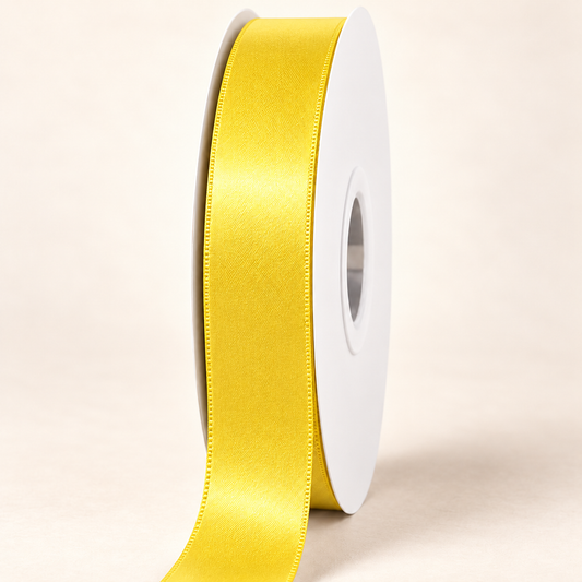 Yellow Gold — 22 mm satin ribbon on a white roll against an ivory background